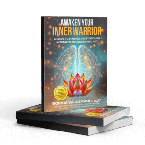 Book titled 'Awaken Your Inner Warrior' with a glowing lotus and warrior silhouette.