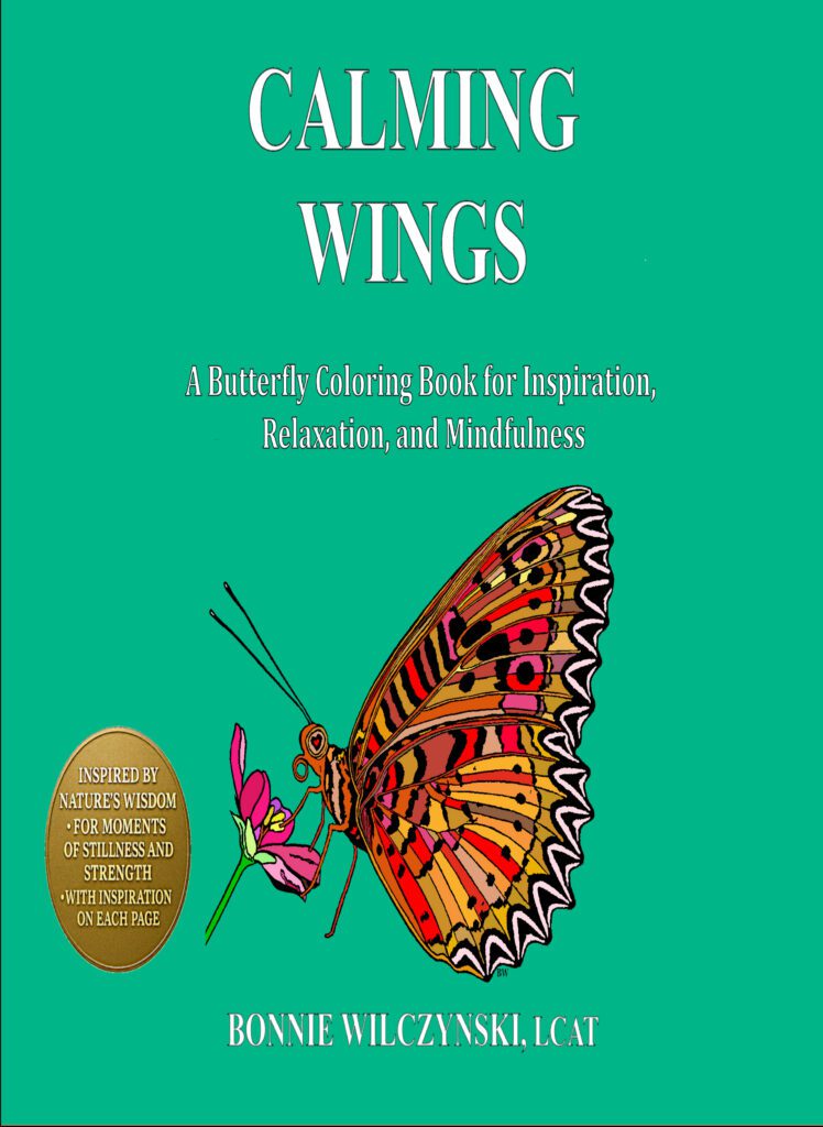 Book cover of 'Wings' featuring a colorful butterfly illustration.
